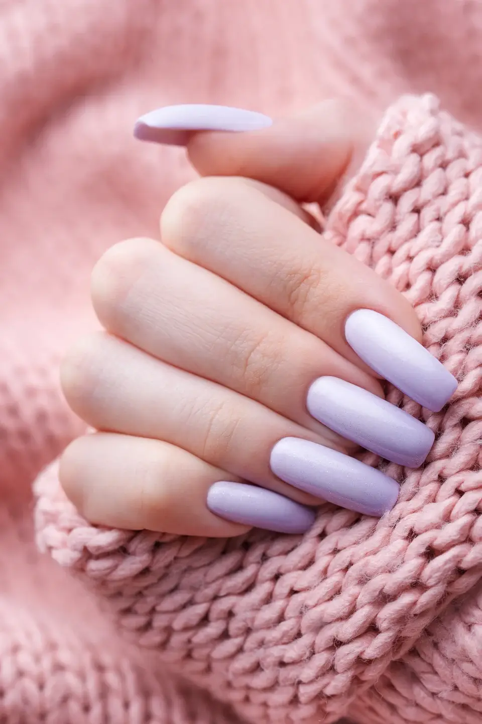 Hand with pastel lavender manicure and pink sweate 2026 03 16 00 36 16 utc