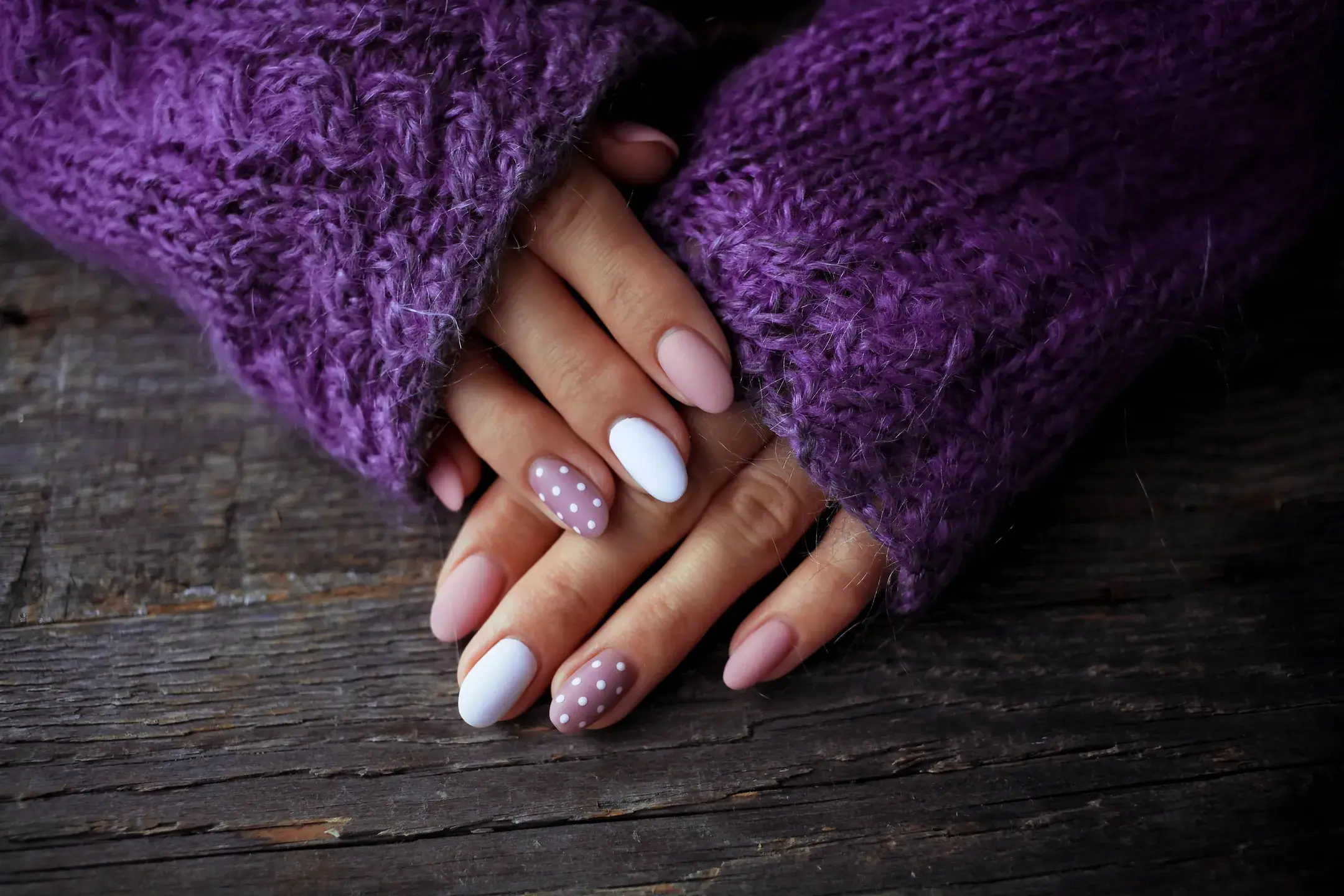 Woman s hands with stylish manicure and purple swe 2026 03 17 17 48 50 utc